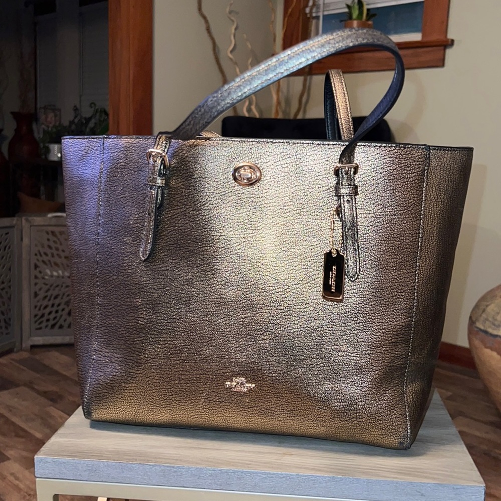 COACH gold 18”x11” tall. Adjustable buckles, interior pockets with zippers